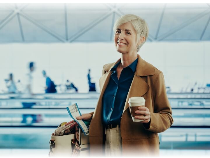 Middle-aged women holding coffee cup at the airport